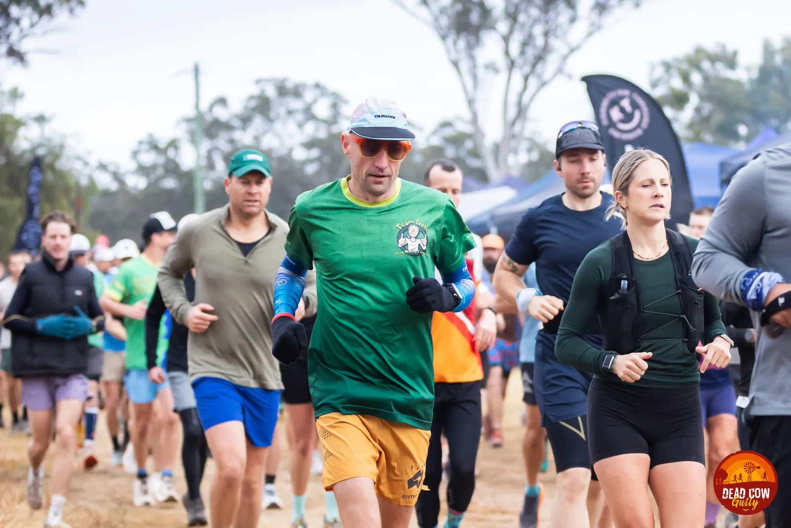 Phil Gore running alongside participants at a backyard ultra event